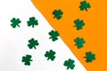 Happy St. PatrickÃ¢â¬â¢s Day. Shamrock pattern on white and orange background.